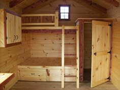 an empty room with wooden walls and cabinets