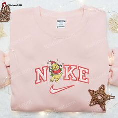 Get into the festive spirit with our Nike x Pooh Candy Cane Christmas Embroidered Shirt. Featuring an adorable Winnie The Pooh Disney design, this Christmas Embroidered T-shirt is the perfect addition to your holiday wardrobe. With its high-quality embroidery, this shirt offers a unique and eye-catching look that will surely make you stand out from the crowd. The Candy Cane Christmas design adds a touch of whimsy and nostalgia to your outfit, reminding you of the joyful and magical holiday seaso Nike Cartoon, Nike Inspired, Embroidered Apparel, Maroon Hoodie, Cartoon Shirts, Beating Heart, Hoodie Material, Custom Nikes, Embroidered Clothes