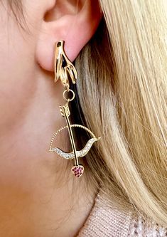 Are you looking for the perfect bow and arrow earrings for someone special this gifting season? Or a unique and handmade gold arrow earrings to spoil yourself and compliment your festive outfits? Made tarnish-resistant stainless steel, dazzling cubic zirconia and plated with 18K gold, my unique Cupid earrings are the perfect compliment to any outfit idea! This pair of gold hand earrings is a great gift idea for any special occasion to all the women in your life. You can't go wrong when gifting my gold bow and arrow earrings! DETAILS - PLEASE READ CAREFULLY: These Cupid bow and arrow earrings are entirely handmade, using the finest materials, and my best skill set. My unique romantic earrings are: -comfortable to wear -safe for sensitive skin -made in Montreal, Canada -measuring 2'' in leng Bow And Arrow Cupid, Gold Bow And Arrow, Cupid Earrings, Cupid Bow And Arrow, Cupid Bow, Hand Earrings, Gold Arrow, Festive Outfits, Romantic Earrings