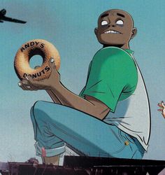 a man sitting on top of a roof holding a doughnut in his hand with the words daddy's famous written on it