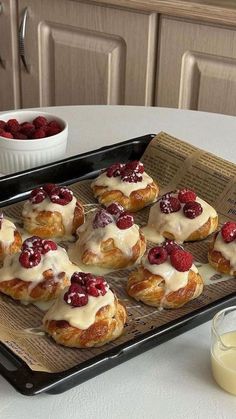 there are many croissants with cream on the top and raspberries on the bottom