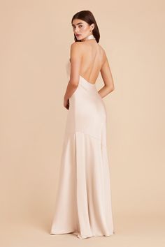 the back of a woman wearing a white gown