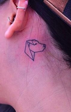 a woman with a small tattoo on her neck and behind the ear is an origami piece