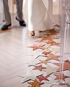 an image of people standing on the floor with star confetti