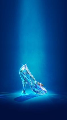 a blue high heeled shoe with a diamond on the side and water around it