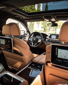 the interior of a luxury car with all leather seats and touchscreens on display