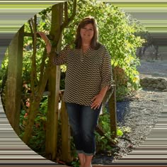 a woman standing in front of a tree