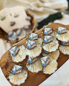 small cookies are arranged on a wooden platter with the words merrim written on them