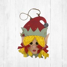 "This Girl Elf from Santa's Family/Christmas door hanger is a must have this holiday season, great for a porch door or a kids bedroom door. Each piece is made from 1/4\" maple wood and layered for a 3D effect. Comes with two holes at the top with a string attached for hanging. Each sign measures 15\" by 11\" Each sign is hand painted and the hair is made out of cloth." Wood Santa, Porch Door, Elf Door, Rustic Christmas Ornaments, Teacher Gift Card, Christmas Gift Card Holders, Girl Elf, Snowman Gifts, Wedding Countdown