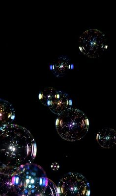 soap bubbles floating in the air at night