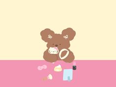 a brown teddy bear sitting on top of a pink table