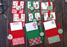 christmas cards and envelopes laid out on top of a wooden table with other items