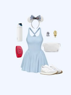 a woman in a blue dress is wearing white shoes and a mickey ears headband