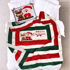 a christmas themed blanket and pillow on a bed