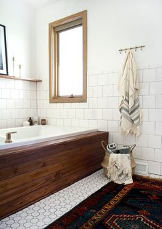 a bath room with a sink and a rug