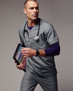 a man with a stethoscope on his arm is holding a binder