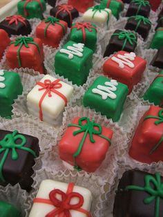 a box filled with lots of chocolates covered in green and red frosted icing