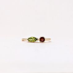 Natural Fine Peridot Garnet Marquise and Round Cut Ring. Semi Precious Gemstone Ring in 14k SOLID GOLD For Her from our Capsule Jewelry Collection. Peridot and Garnet Gemstones are set in  Bezel Setting in our Factory. Gold Ring AA+ Quality. Perfect Gift For Everyday or August Birthstone Gift for Your Loved Ones. ►  DIMENSIONS : ◆ Gemstone : Peridot 0.30 Cts                         : Garnet 0.10 Cts ◆ Stone size : Peridot  6*3 mm                                          : Garnet  3*3 mm ◆ Shank Width : 1 mm      ◆  Material :  14k Yellow Gold          Made to Order      EACH Ring is Stamped With 585 Marked As 14k GOLD International Standard. All my gemstones are hand-selected for best quality assurance, then precisely sawed, and shaped into the desired geometry. The Semi precious stones ar Mixed Gemstone Rings Garnet Peridot And Diamond Heart Shape, Fine Jewelry Marquise Multi-stone Ring, Fine Jewelry Stackable Multi-stone Open Rings, Stackable Peridot Anniversary Jewelry, Wedding Jewelry With Peridot Gemstone Accents, Fine Jewelry Stackable Open Rings With Multi-stone, Stackable Peridot Jewelry For Anniversary, Peridot Gemstone Wedding Jewelry, Fusion Style Promise Ring With Accent Stones