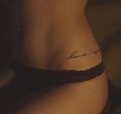 a woman with a tattoo on her stomach that says, please to my mom in cursive writing