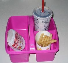 a pink tray with fries and drink on it