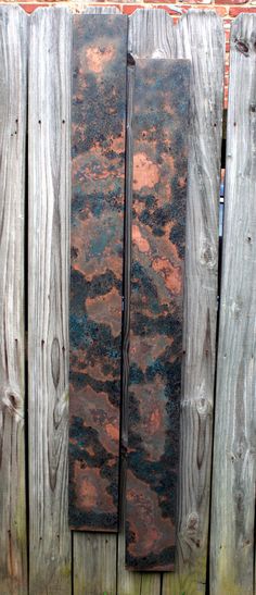 an old rusted metal door on a wooden fence