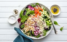 a salad is shown with dressings on the side