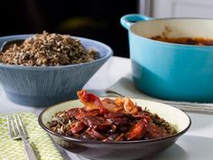 two bowls filled with food sitting on top of a table