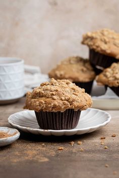 some muffins are sitting on a white plate