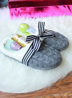 a pair of slippers sitting on top of a white fur covered floor