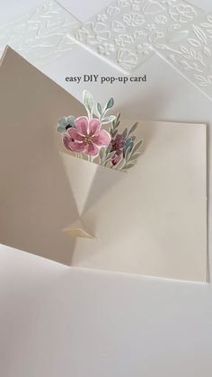 an easy diy pop up card with flowers on it