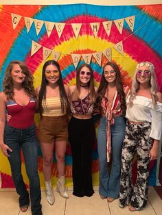 four girls are posing in front of a tie - dyed backdrop with the words cheetah days on it