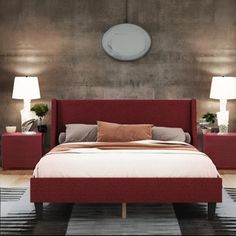 a red bed with two nightstands and a round mirror on the wall above it