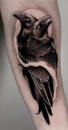 a black and white bird tattoo on the leg