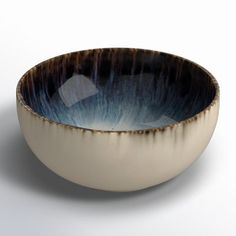 a white and blue bowl sitting on top of a table