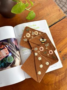 the book is open to show an image of some food and flowers on top of it