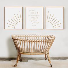 two framed art prints on the wall above a wicker chair