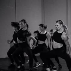 a group of women in black and white dancing