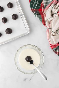 an image of chocolates in a bowl and on a tray next to the doughnut holes