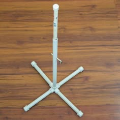 four white poles are arranged on a wood floor