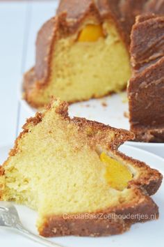 a piece of cake on a white plate with a slice cut out and ready to be eaten