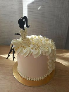 a cake decorated with white frosting and flowers