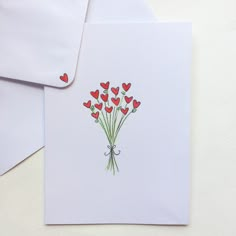 a bouquet of red hearts on a white envelope