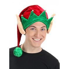 a man wearing a green and red elf's hat with horns on his head