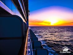 the sun is setting over the ocean on a cruise ship