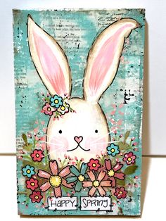 "Spring Bunny Sign 5.5x9\" mixed media wood \"Happy Spring\" You can now purchase my art in 3 ways Original Art- This is my art made for you with all the layers of media to create amazing texture. I layer many types of paper, fabric, tissue, poem book pages and sheet music to create an interesting texture to paint my designs on. As you can see from the pictures the words and music peek through the paint. The sides and backs are finished and I have added inspiring words along the edges too. Seale Spring Flower Decor, Poem Book, Wood Bunny, Bunny Sign, Vintage Easter Cards