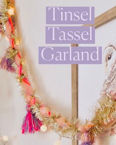 a clock with tinsel tassel garland hanging from it's sides and the words tinsel tassel garland on top