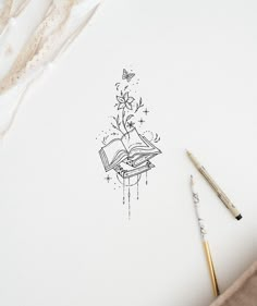 an open book sitting on top of a table next to a pencil