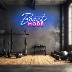 an empty gym room with exercise equipment and neon sign that says beat mode on the wall