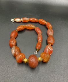 The Rare Unique PEMA RAKA Carnelian Amulet Prayer Beads Necklace From Himalayan Tibet The Age Of This Beads Are More than 1000 years Old As You Can See From Its Conditions Very Oily Smooth Skin Of This Pema Beads Some Gold Plated Wax and Gold Color Brass Beads Are Used As Spacers Rare Items For Collections Orange Agate Oval Beads Jewelry, Orange Agate Oval Beaded Jewelry, Traditional Carnelian Gemstone Beads, Artisan Carnelian Beaded Necklaces With Oval Beads, Carnelian Amulet Beads And Cabochons, Artisan Carnelian Beaded Necklace With Oval Beads, Carnelian Large Beads For Gifts, Carnelian Round Beads, Traditional Carnelian Oval Beads