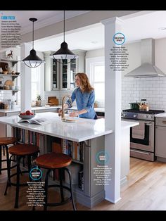 a woman is standing at the kitchen island